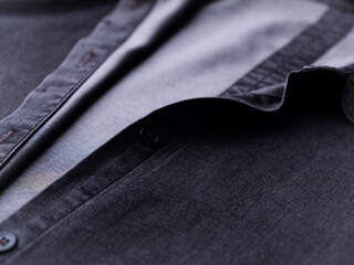 Close up of dark Men's shirt. Soft focus. Copy space.	