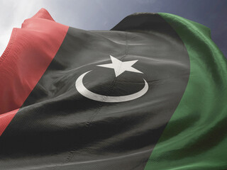 Waving Flag of Libya in Blue Sky. Libya Flag on pole for Independence day. The symbol of the state...