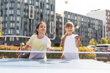 Little children playing ping pong in park