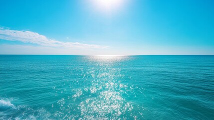 Obraz premium The ocean is calm and clear, with a bright blue sky above