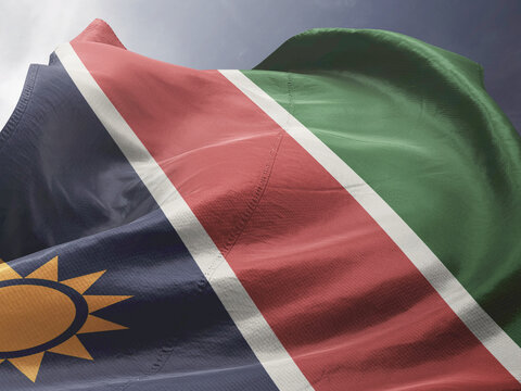 Waving Flag of Namibia in Blue Sky. Namibia Flag on pole for Independence day. The symbol of the state on wavy fabric.