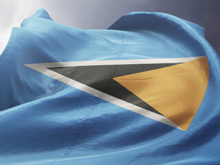 Waving Flag of Saint Lucia in Blue Sky. Saint Lucia Flag on pole for Independence day. The symbol...