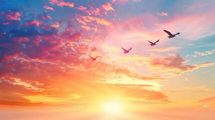 Fototapeta premium Beautiful sunset sky with vibrant colors and birds flying peacefully in the tranquil atmosphere, creating a serene and picturesque scene.