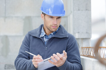 handsome foreman making notes on a clipboard © auremar