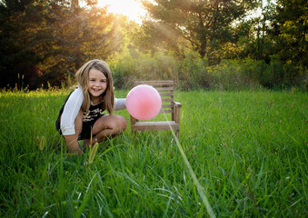Happy young girl doing science experiment outdoors