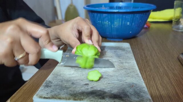The process of cutting green chayote vegetables, on a white cutting board, cooking process, stock video.
