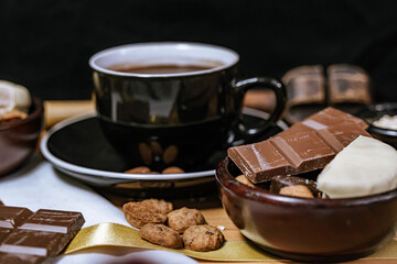 Chocolate chip cookies, dark and white chocolate bar, small bowl of oatmeal and nuts. International Chocolate Day.