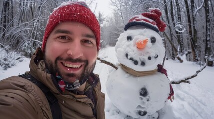 Fototapeta premium A man in winter clothes takes a selfie with a snowman
