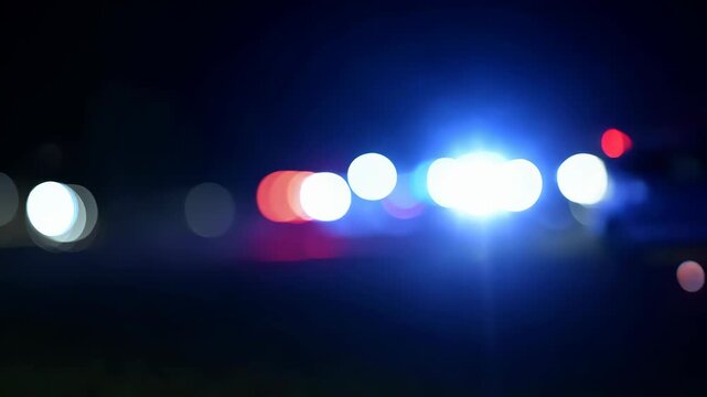 Siren Glow: Defocused Red and Blue Police Lights at Night
