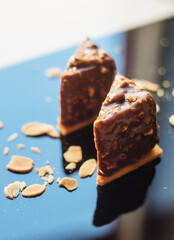 Mini dessert in a modern version. Portion cheesecake covered with chocolate and nuts. Fashionable French chocolate cake.
