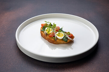 Delicious bruschetta with fish, cheese and herbs