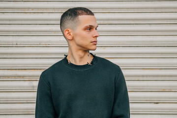 portrait young man on the street looking in profile