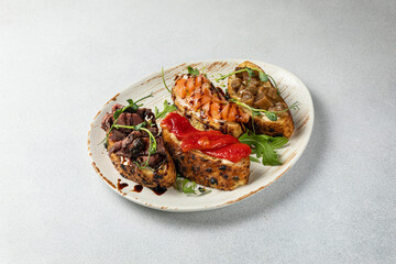 Delicious bruschetta with fish, cheese and herbs