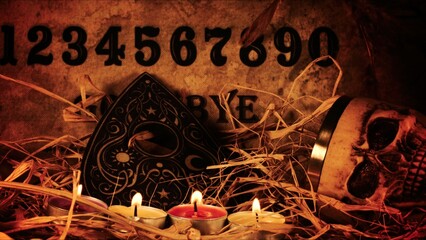 Creepy Skull on a Witchcraft Ouija Board and Candles