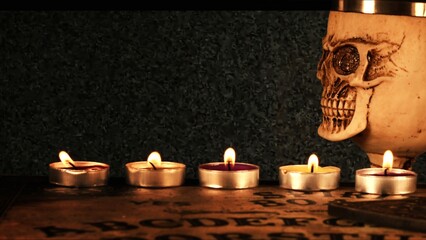 Creepy Skull on a Witchcraft Ouija Board and Candles