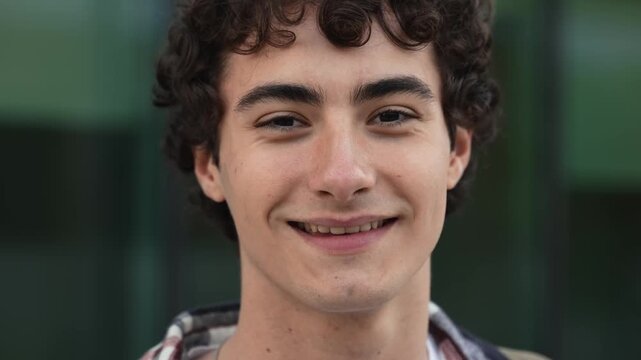 Close up face of young Spanish man - Teenager student smiling to camera
