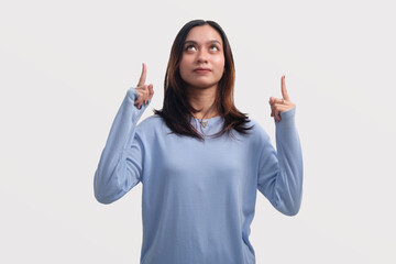 Excited Asian woman pointing something above