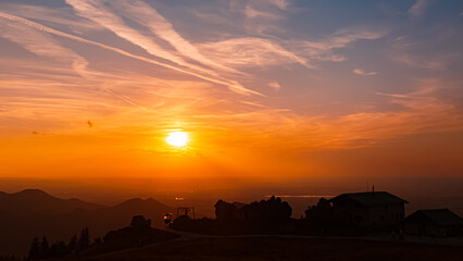 Obraz premium Alpine sunset or sundowner with the silhouette of Steinlingalm at Mount Kampenwand, Aschau, Chiemgau, Rosenheim, Bavaria, Germany