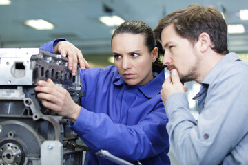 foreman explaining working of a motor to female trainee