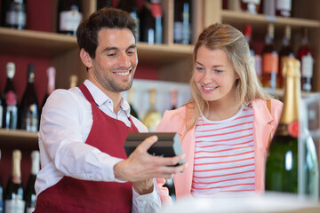 sommelier with female customer in wine cellar