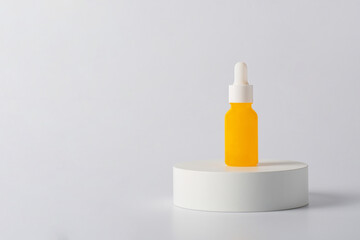 Yellow glass cosmetic bottle, Skin care or sunscreen cosmetic with stylish props on white background.