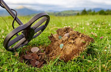 Treasure hunter with a metal detector in the mountains.