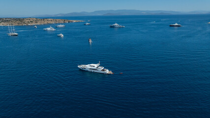 Obraz premium A breathtaking aerial view of a luxurious yacht cruising on the blue waters