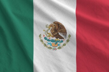 Mexico flag depicted on folded wavy fabric of old cloth close up