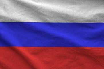 Russia flag depicted on folded wavy fabric of old cloth close up
