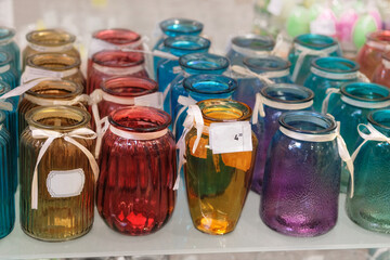 Variety of glass flower jars are sold in store.