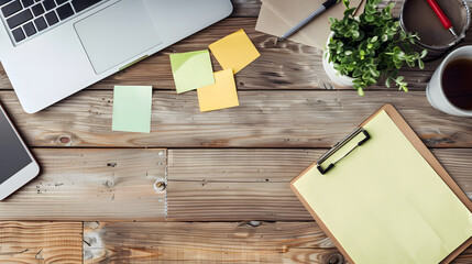 White adhesive note paper with handwritten reminders on a wooden office desk