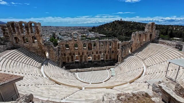 Profile view of Odeon of Herodes Atticus on a sunny day at the Acropolis of Athens, Greece.