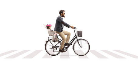 Father riding a child in a bicycle seat at a pedestrian crossing