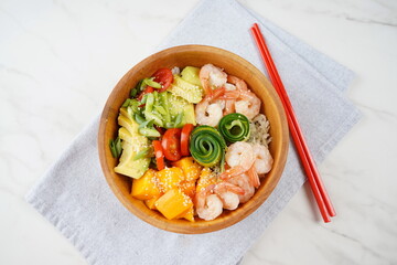 Fresh seafood recipe. Shrimps poke bowl with rice, green onions, tomatoes,avocado,mango. Food...