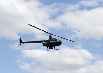 Small Helicopter  flying over the  blue  cloudy  sky 