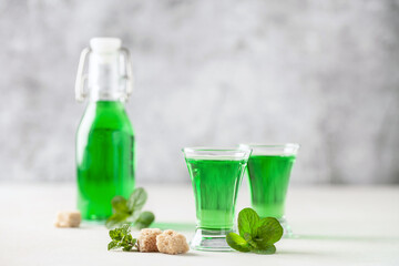 Sweet refreshing mint liqueur in glasses with mint leaves