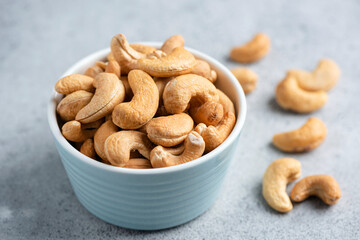 Salted cashew nuts in bowl closeup view, healthy food