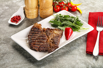 Grilled chuck roll steak with arugula