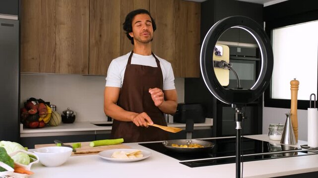 Professional chef demonstrating culinary skills in a modern kitchen, engaging with viewers