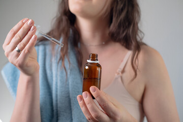 Fototapeta premium Brown bottle of face serum, highlighting higher concentration of active ingredients compared to creams and lotions for targeted skincare.