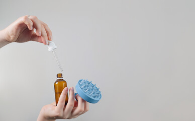 Scalp massage brush and oil bottle, Enhances scalp health by removing dead skin cells and preventing dryness and itchiness.