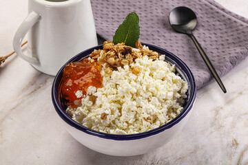 Curd with granola and orange jam