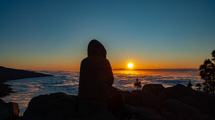 Man enjoying the sunset in the mountains