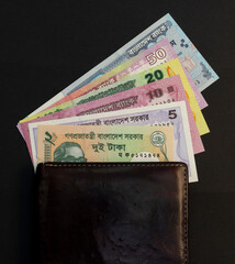 Bangladeshi money in a wallet on black background