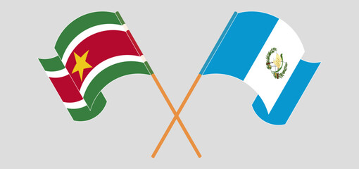 Crossed and waving flags of Suriname and Republic of Guatemala