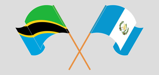 Crossed and waving flags of Tanzania and Republic of Guatemala