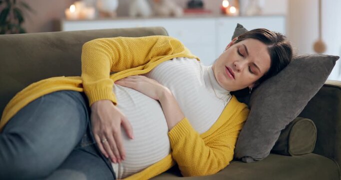 Home, pregnancy and woman with pain in stomach for labor contractions, preeclampsia and sick on sofa. Pregnant lady, healthcare problem and cramps on couch for constipation, stress and miscarriage