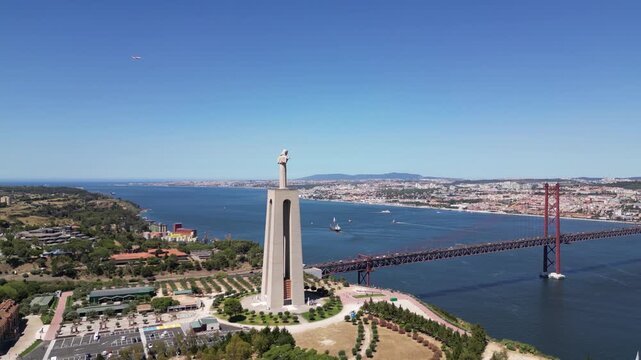Drone footage of the Sanctuary of Christ the King statue overlooking Tagus River in Almada, Portugal