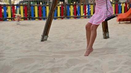 Girl on a Swing Set at the Playground
