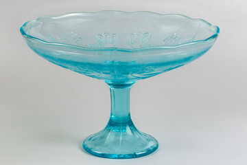 Empty vintage blue glass vase for fruits on a leg